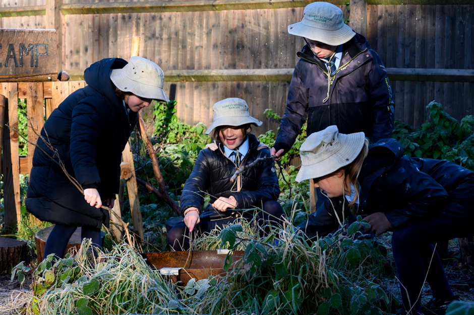 children weeding raised beds