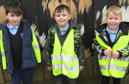 Boy's in high visibility vests, on a school trip