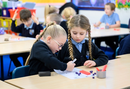 Girls working on maths in the classroom