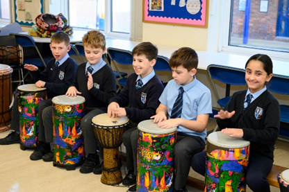 children playing African djembe drums