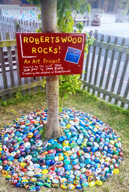 Painted rocks around the base of a tree