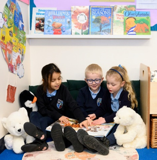 Children reading with stuffed toys